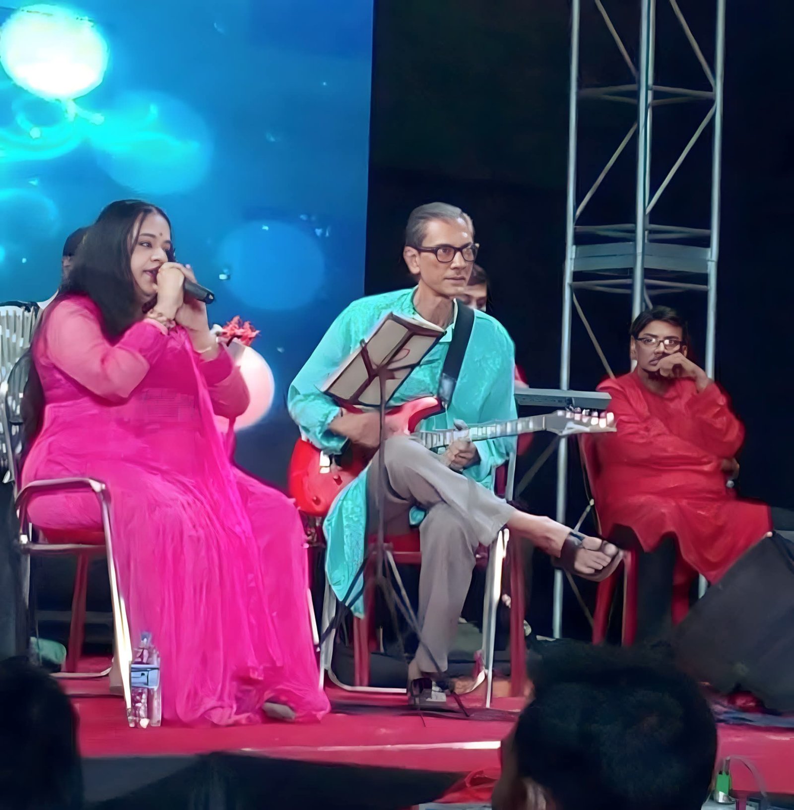 Banasri Ghoshal seated on stage with her musicians